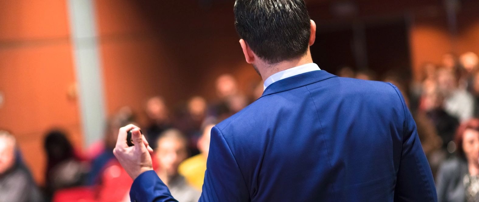 Banking regulatory expert presenting supervisory policy to financial professionals at a conference