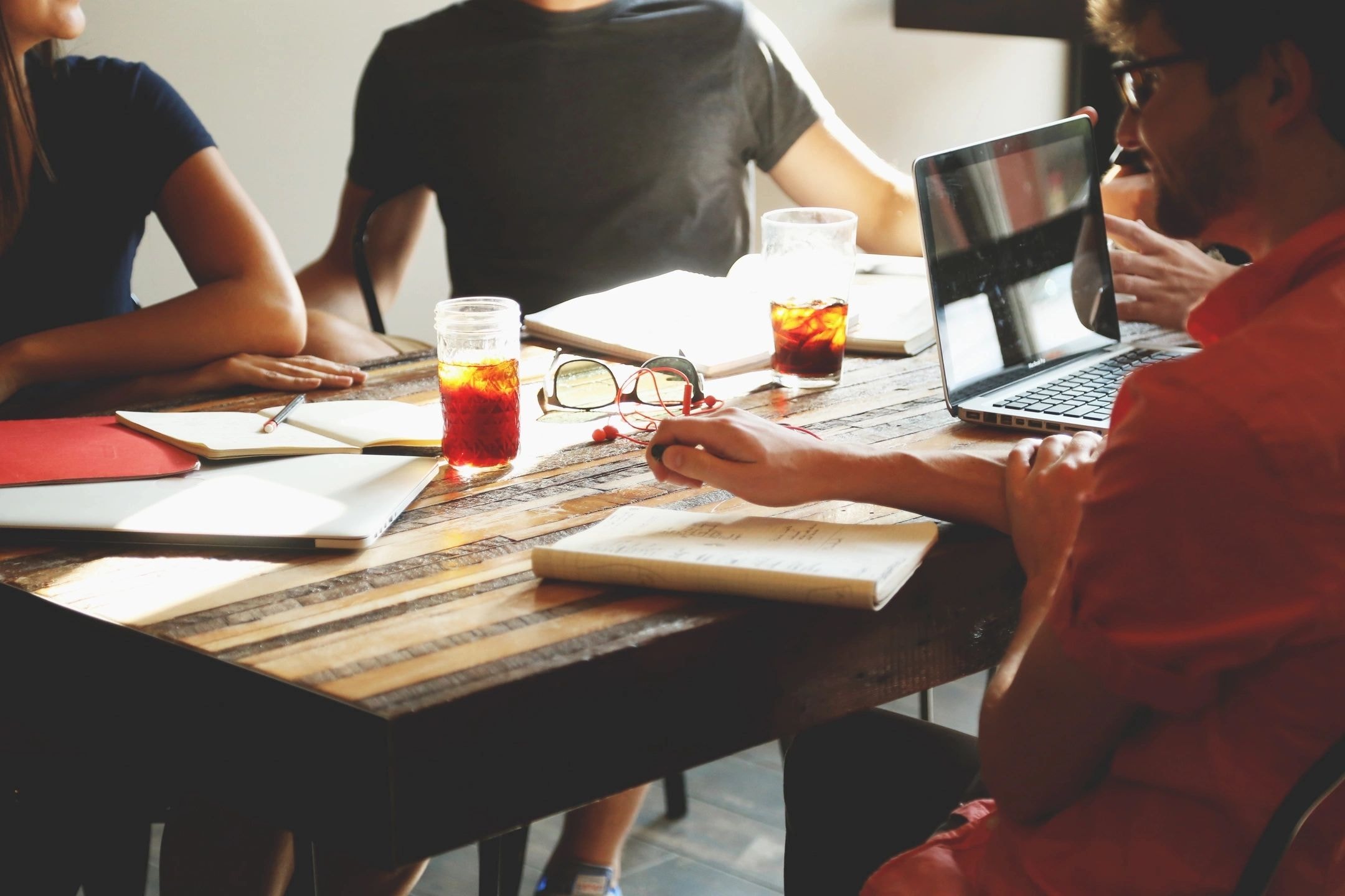 Consulting team collaborating around a table to develop banking regulatory strategy